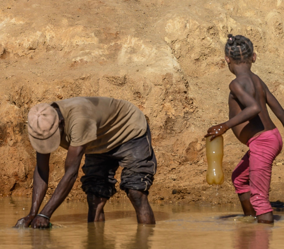 Children collecting water from a river in Madagascar